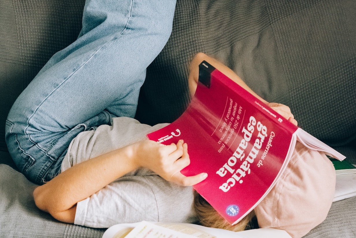 girl reading spanish grammar book