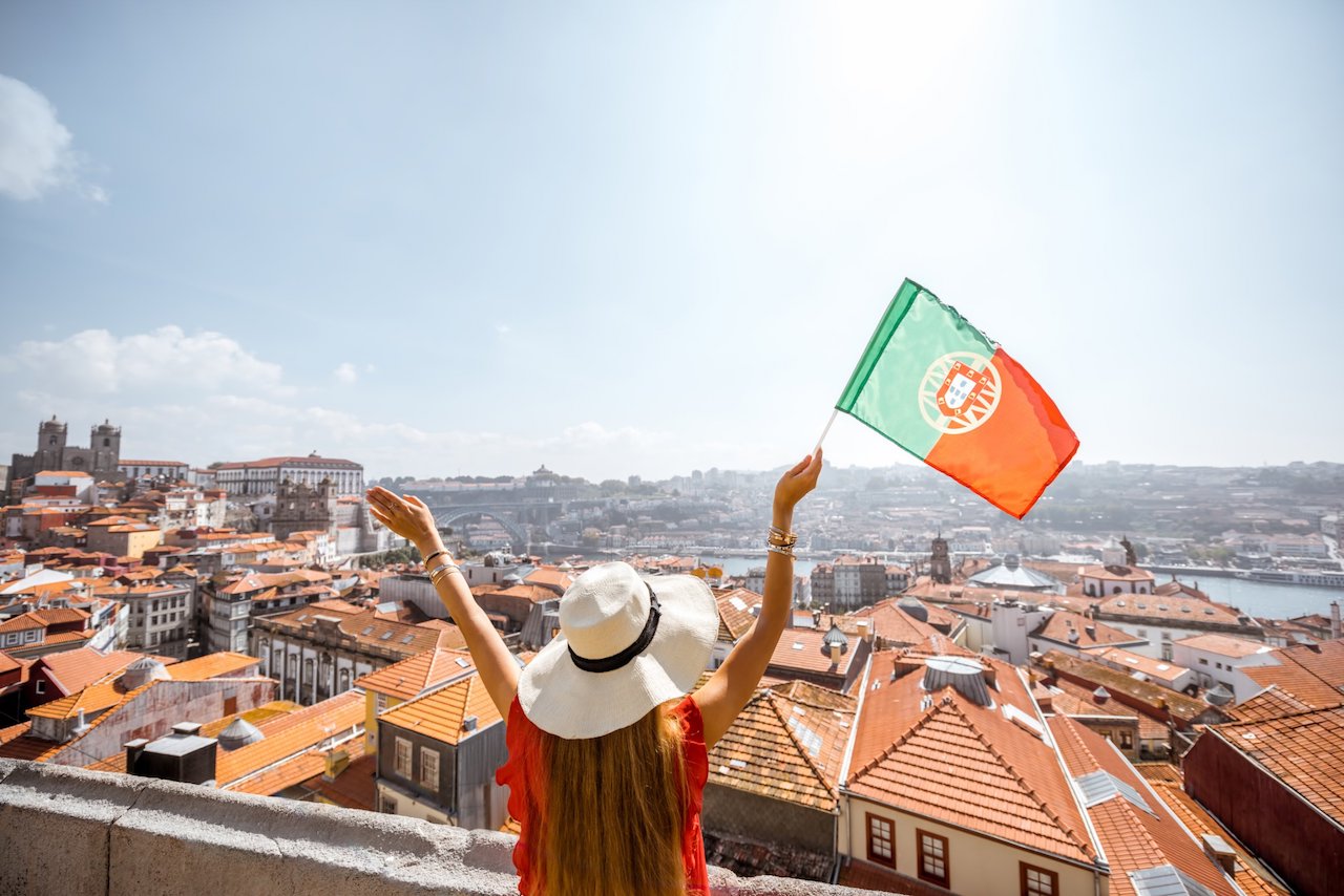 student holding a portuguese flag