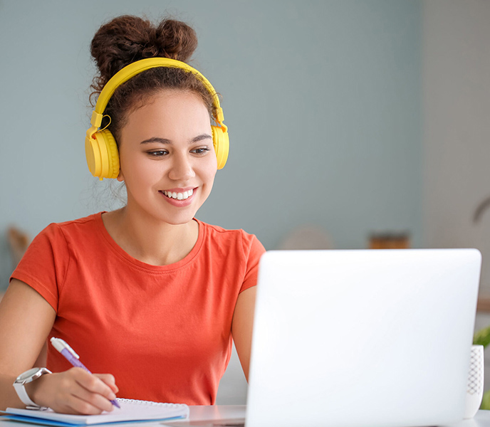 Young woman using laptop for online learning at home